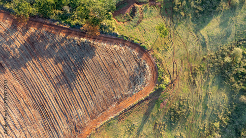 Top Down Aerial View of Plowed Farmland and Green Pasture