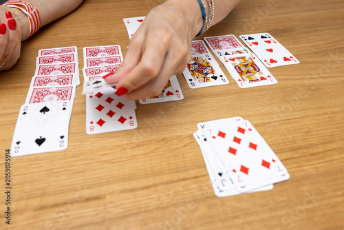 Fotografie Woman's hands holding a fan of playing cards — card game, leisure, entertainment