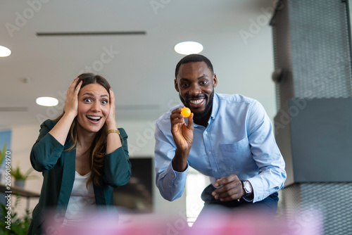 Colleagues playing a game, having fun at office party
