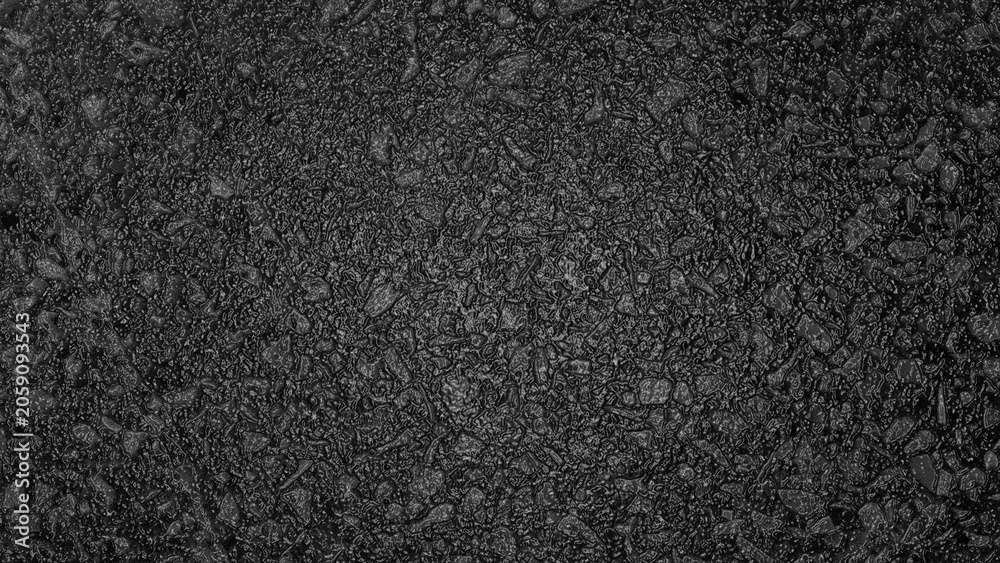 Fototapeta premium Close‑up of dark asphalt surface with embedded gravel and coarse texture, showing detailed irregular patterns and subtle variations in tone.