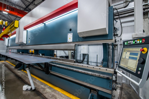 Large industrial machine dominates factory floor