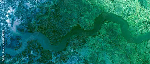 Obraz  z motywem River winding through green landscape showcases nature's design in a remote area during daylight