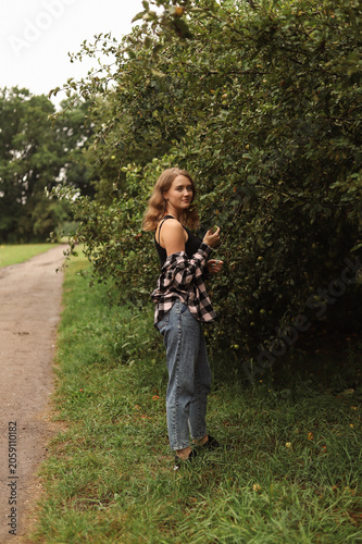 Harmony with nature: portrait of a girl near an apple tree.