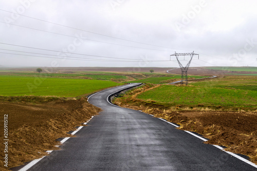 Scenic lakeside highway through green countryside landscape