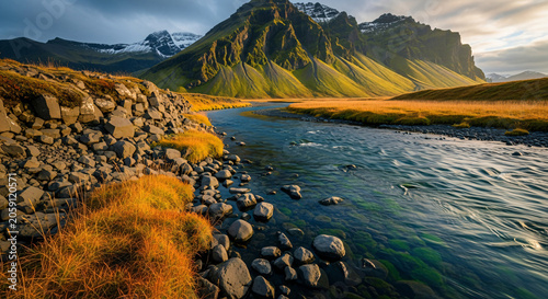 Mountain River Landscape With Rocks Grass And Snow Peaks