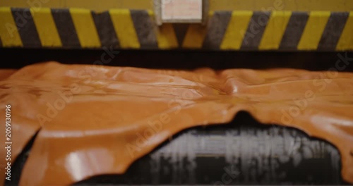 Orange protective tarp under black and yellow hazard barrier