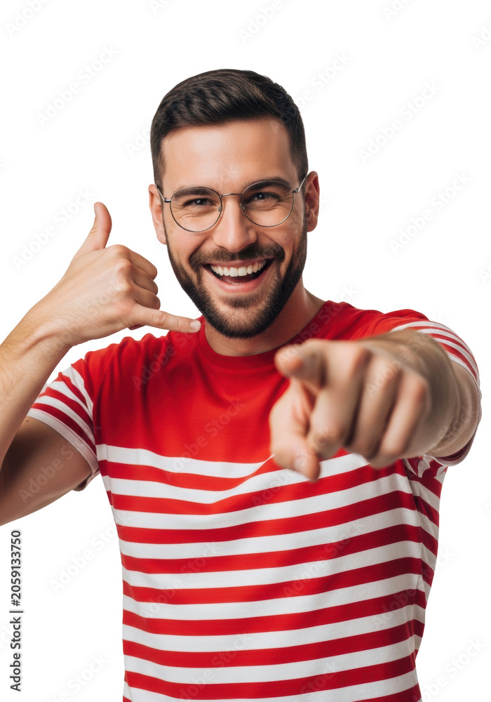 Naklejka premium Young caucasian man, beard, round glasses, and striped t-shirt, pointing and gesturing 'call me' with a cheerful smile in a high-key studio portrait. concept for urgent communication