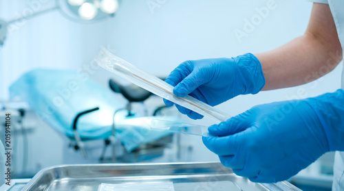 Healthcare professional prepares sterile medical instruments for examination
