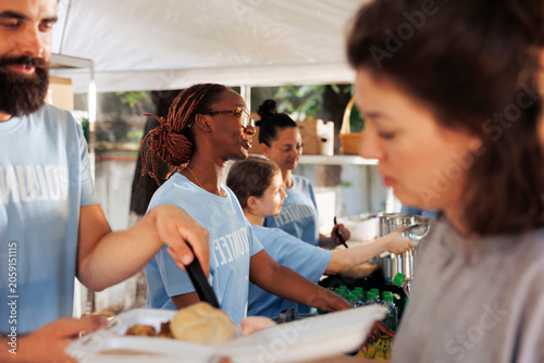 Fotografie Image showcases power of humanitarian aid, as nonprofit organization addresses hunger relief and poverty with food drive efforts; volunteers unite, distributing food to poor and homeless people
