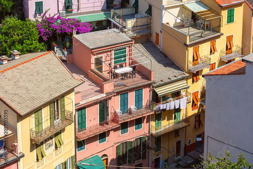Colorful residential buildings with balconies and rooftop terraces in the village of Manarola, Cinque Terre, Italy.
