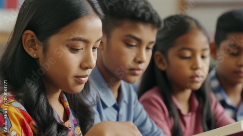 Students concentrating during classroom activities, demonstrating dedication, teamwork, academic engagement, and commitment to educational achievement.