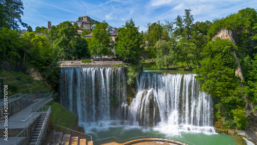 Obraz na plátně Aerial Drone View of Majestic Pliva Waterfall and Historic Jajce Fortress in Bos