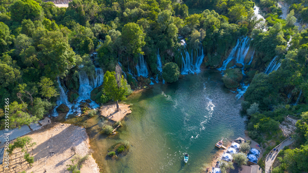 Fototapeta premium Scenic Aerial Drone View of Kravica Waterfall and Emerald River Pool in Bosnia and Herzegovina