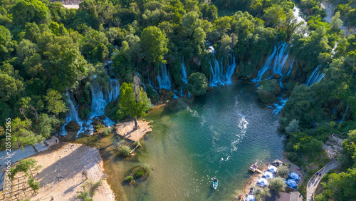 Obraz na płótnie Scenic Aerial Drone View of Kravica Waterfall and Emerald River Pool in Bosnia a
