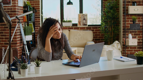 Bilde på lerret Self employed woman feeling ill, struggling to concentrate while working from home, hurting from headache, exhausted freelancer suffering from sickness and stress while working on laptop