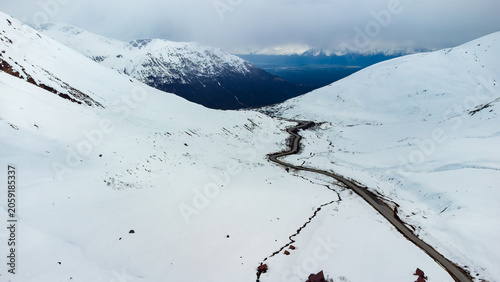 Snow-Covered Mountains and Winding Road
