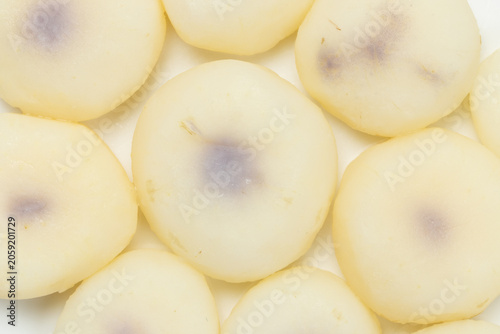 boiled and peeled water chestnuts arranged on a white background, Top view