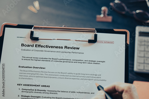 Board Effectiveness Review: Realistic clipboard-up placed on  with clips, calculator, pen. Contributor-created fictional business document for illustrative purposes.
