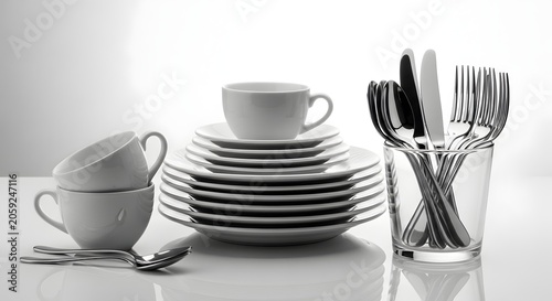 Elegant White Dinnerware Set with Cups Plates and Silverware on Reflective Surface