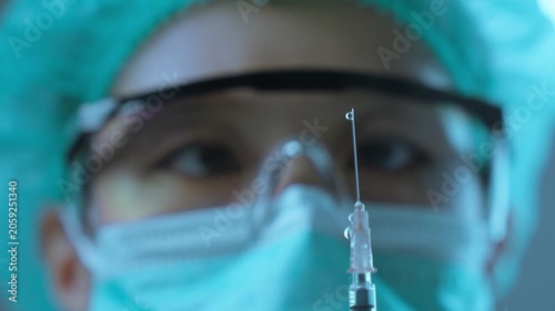 Medical Researcher Focusing on Sterile Syringe for Precision Laboratory Work