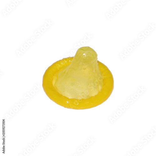 Yellow condom with selective focus in studio lighting for safety concept