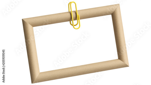 Simple brown cardboard rectangular frame held by a yellow paperclip on white