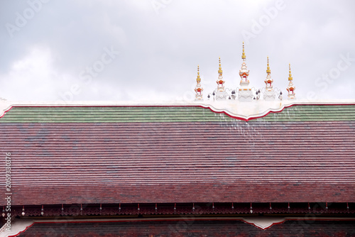 Thai temple roof on white clouds sky background