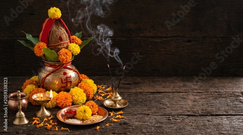 Mahalaya Amavasya, ritual kalash, marigold flowers and incense smoke arranged on dark textured background