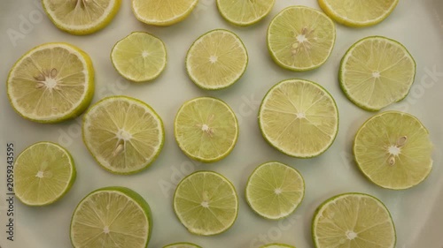 Lemon slices on a plate rotation top view.