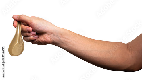 Male hand holding a gold plastic spoon isolated on white background.