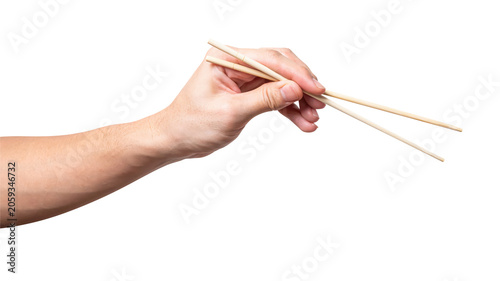 Male hand holding a wood chopstick isolated on white background.