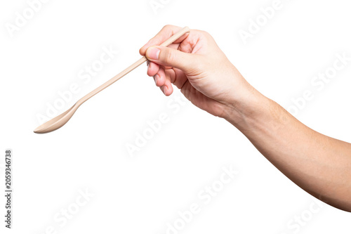 Male hand holding a brown plastic spoon isolated on white background.