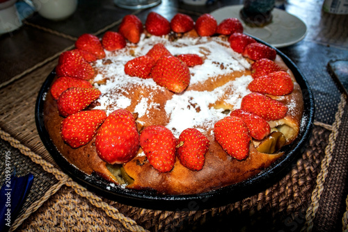 round sweet homemade cake with Victoria in a plate