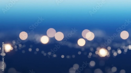 Abstract blue gradient background with glowing bokeh circles and tiny white particles in calm motion