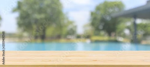 Panel kuchenny z motywem Empty wood table top with blur outdoor swimming pool in tropical resort hotel summer background