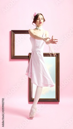 Delicate Ballet Dancer in Pink Dress and Flower Hair Accessory Performing