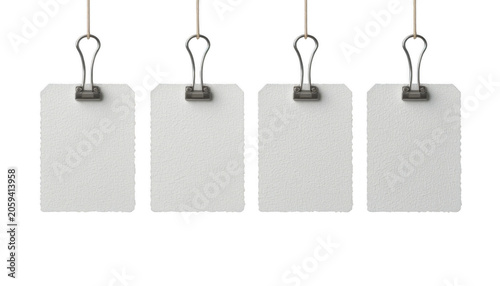 Labels made of white paper hang vertically from silver clips to offer a clean and professional space for writing notes, prices, or inventory details in a retail or office setting.