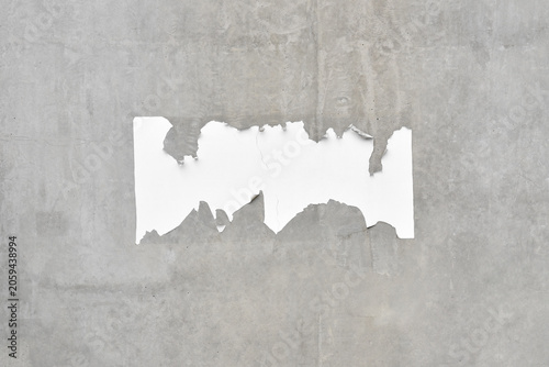 Konstfotografi scrap of ripped advertising poster on raw concrete wall with copy space