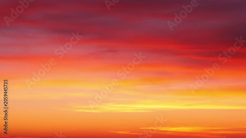 Vibrant sunset sky with dramatic clouds painted in fiery shades of orange, red, and purple hues