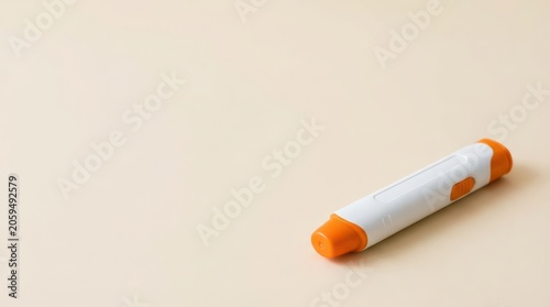 Orange and white epinephrine autoinjector pen on neutral background for food allergy emergency awareness and medical poster or safety design. Copy space