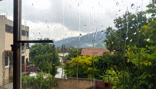 Raindrops on window reveal a scenic, rainy day view