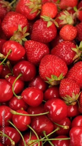 Mix fresh cherry and strawberry close up, rotation