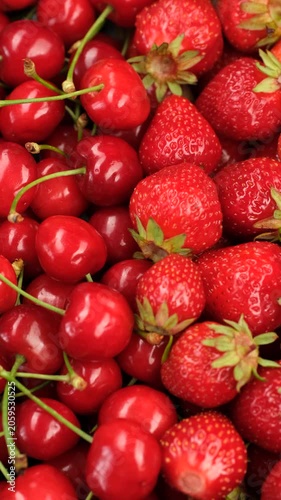 Heap of fresh cherry and strawberry close up, slider view