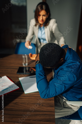 Obraz na plátně Coworker supporting stressed man suffering from burnout