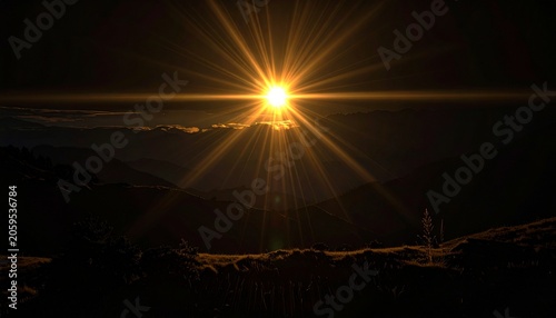 Golden sunburst over silhouetted mountain range