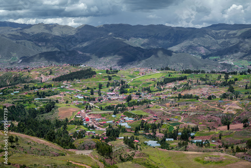 Obraz na płótnie Rural Sacred Valley stretches into the distance with patchwork fields, scattered villages, and cloudy mountain scenery