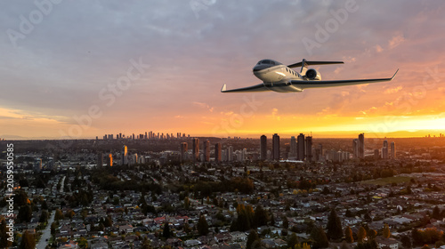 Photos Private Business Jet Flying Over City Skyline At Sunset With Background in BC, C