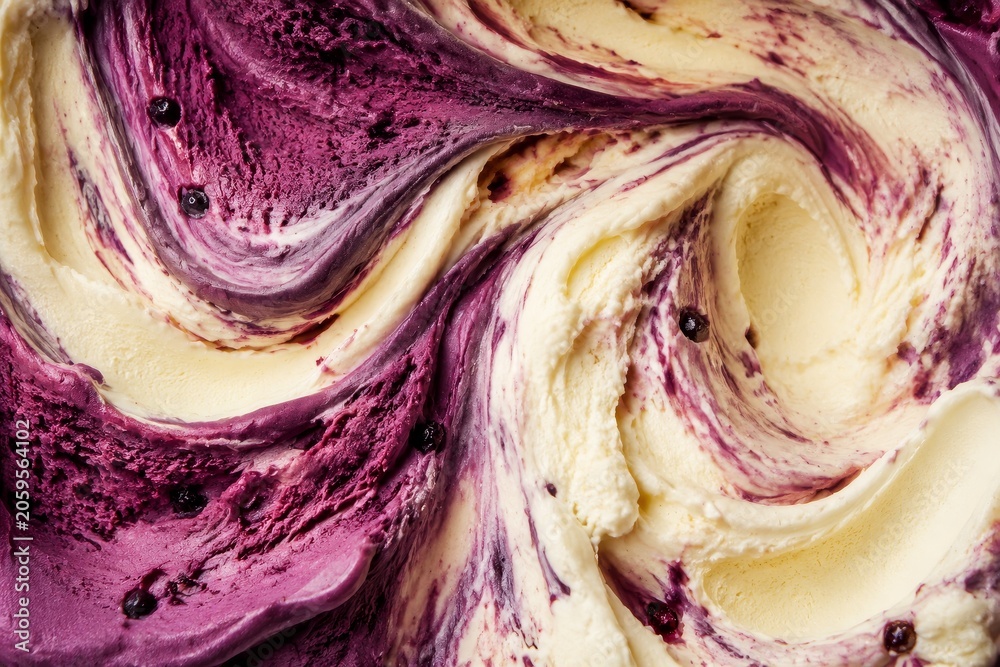 Obraz premium Close up of vanilla ice cream with blueberry swirl. Cold dairy dessert texture with fruit ripple. Refreshing summer treat and gourmet food background for menu design and culinary concept.