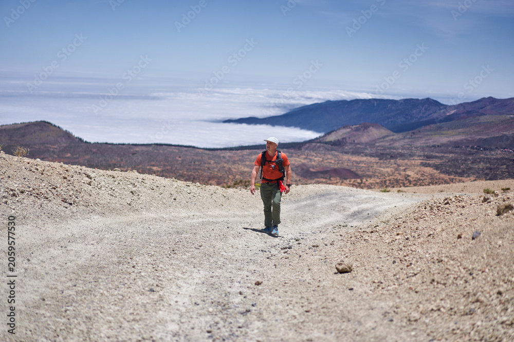 Fototapeta premium Male hiker above sea of clouds Teide
