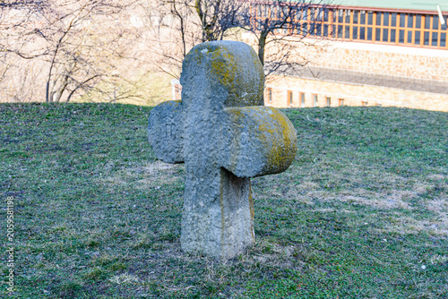 Ancient cross at the yard of Saint Elias Church in village Subotiv. Cossack burial
